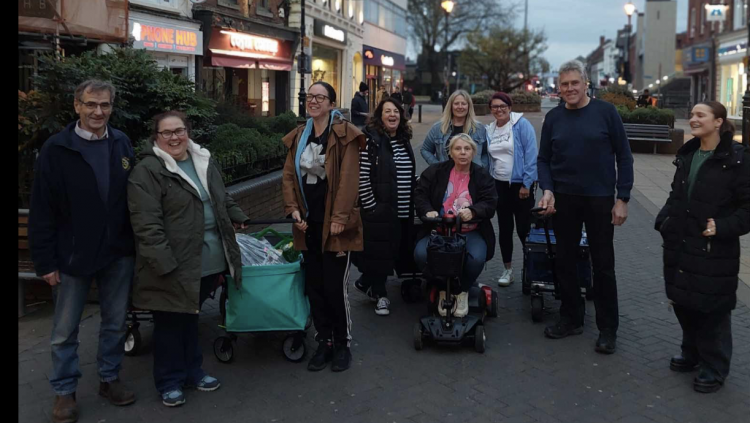 Marion Foster (4th from right, front) with volunteers delivering meals to Lincoln's homeless community on Monday evening.